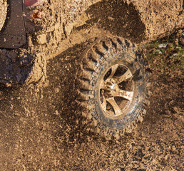 SUV wheel stalled in mud and water