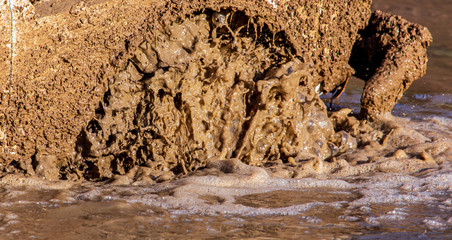 SUV wheel stalled in mud and water