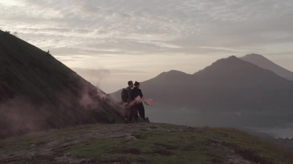 Travelers with colored smoke among mountains