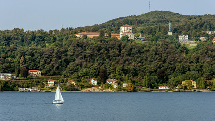 Sailboat on Lake Maggiore with the Colossus of San Carlo Borromeo in the background, Arona, Italy