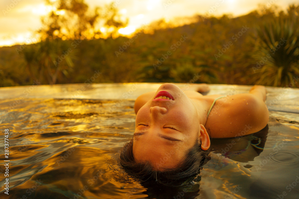 Wall mural tropical holidays lifestyle portrait of young beautiful and happy asian japanese woman in bikini enj