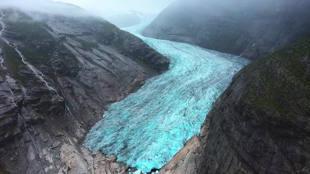 Aerial view big glacier Nigardsbreen in Norway. Blue ice glacier -travel background. Summer in Nigardsbreen Glaciar. Natural park jostedalsbreen. Region Norwegian Fjords.