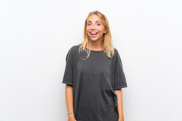 Fototapeta premium Blonde young woman over isolated white background with surprise facial expression