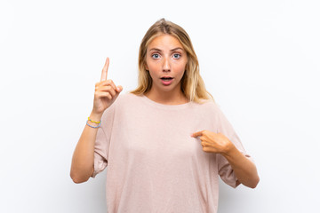 Blonde young woman over isolated white background with surprise facial expression