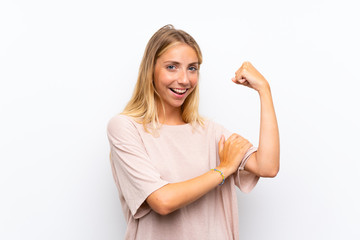 Fototapeta premium Blonde young woman over isolated white background making strong gesture
