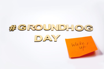 Groundhog day concept with sticky note "Wake up"