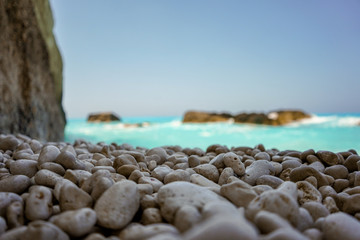 Fototapeta na wymiar beautiful clear sea. a wave swam across the colored sea pebbles on the shore.