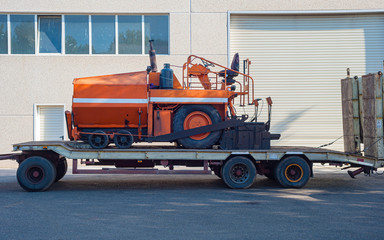 Asphalt bitumen paver and an truck with trailer. For the renewal of the asphalt