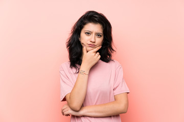 Young woman over isolated pink background thinking an idea