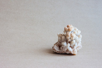 Small white marble cubes on brown paper.