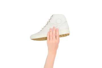 White leather shoes in woman hand isolated on white.