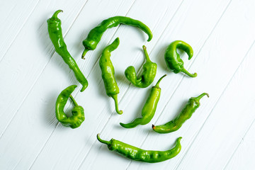 Creative layout with hot peppers in on a white wooden background with copy space. Top view food. Eco vegetables without nitrates, GMO. Natural Fresh Farm Products. Food photo background. Flat lay
