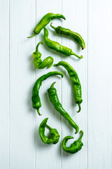 Creative layout with hot peppers in on a white wooden background with copy space. Top view food....
