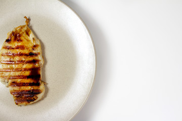 chicken steak on a plate with spices