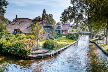 Giethoorn Netherlands, iew of typical houses of Giethoorn. The beautiful houses and gardening city is know as "Venice of the North".
