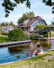 Giethoorn Netherlands, iew of typical houses of Giethoorn. The beautiful houses and gardening city is know as "Venice of the North".