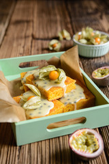 Sweet potato dessert topped with passion fruit sauce and decorated with ground cherries