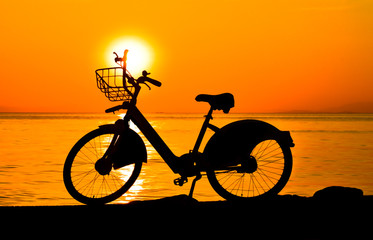 silhouette of bike with basket on sunset