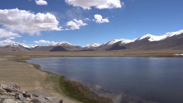 Pamir Highway Bulunkul Lake Breathtaking Picturesque View with Snow Capped Mountains at Background on a Sunny Blue Sky Day