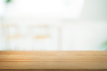 Wooden tabletop in front of montage blur restaurant cafe or kitchen background.