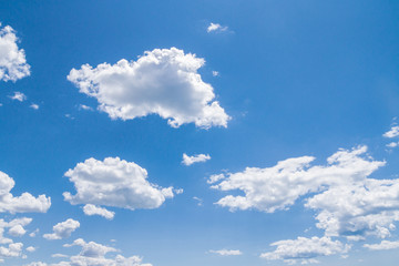 Naklejka na ściany i meble White fluffy clouds in the blue sky in summer