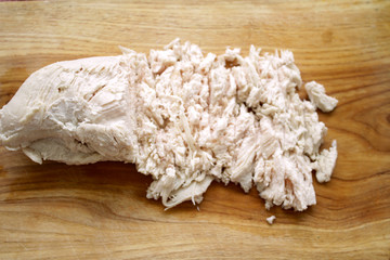 boiled chicken meat sliced on a board