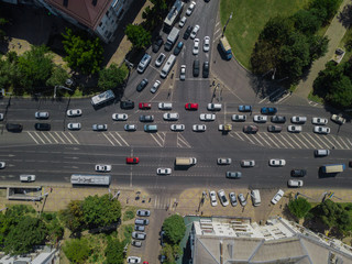 Aerial road abstract: top down view of urban city traffic at rush hour, transportation concept.