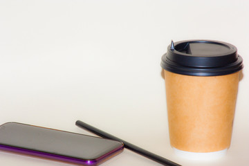 pen and cup of coffee on white background