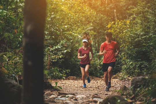 Runners. Young people  trail running on a mountain path. Adventure trail running on a mountain. Runners receive injuries from running trails on a mountain