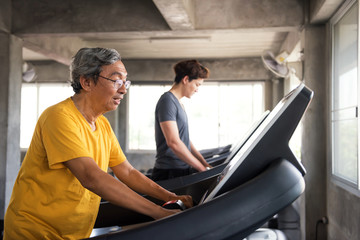 Fototapeta na wymiar Senior and young men exercise in gym