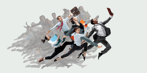 Happy office workers jumping and dancing in casual clothes or suit with folders on white. Ballet...
