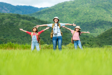 Group asian family children raise arms and standing see mountain outdoors, adventure and tourism for destination leisure trips for education and relax in nature park. Travel vacations and Life Concept