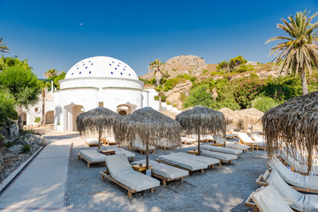 Kalithea Spring Therme Chairs on Beach with Pebbles and Bamboo Umbrella,Rhodes,Greece