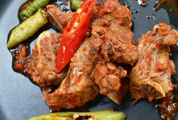 spicy stir fried pork bone with chili and Chinese long bean on plate