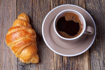 Croissant with coffee cup