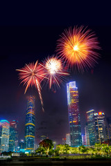 Fototapeta premium Celebration firework in twilight night cityscape of guangzhou urban skyscrapers at storm with lightning bolts in night purple blue sky, Guangzhou, China