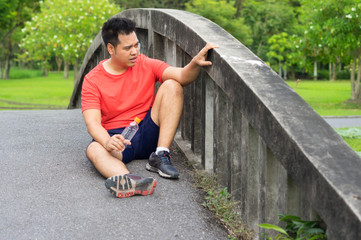 Asian man tired from running exercise.