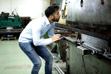 The engineer oversees the process of working in an electrical workshop,stock photo