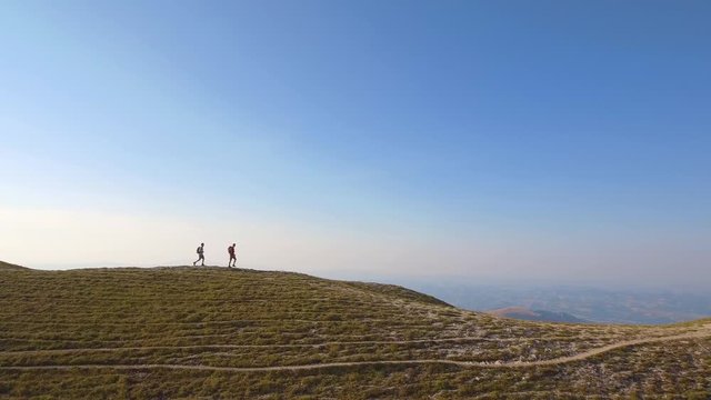 Drone view of two friends hiking in the Apennines, Umbria, Italy