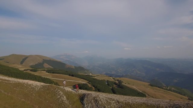 Drone view of two friends hiking in the Apennines, Umbria, Italy
