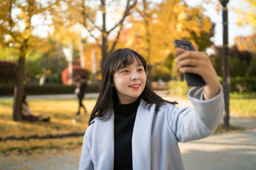 portrait of young woman in autumn park