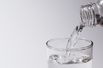 water in glass put on table under the blue sky reflection for healthy or drink, nature concept.