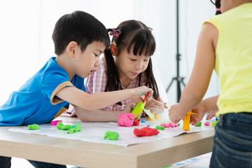 children playing clay coloured on the table back to school concept