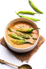 Hyderabadi mirch/mirchi ka Salan or green chilly sabzi or curry. Main course recipe from India. served in a bowl. selective focus