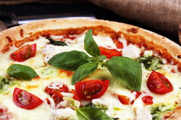 vegetarian italian Pizza with tomatoes, mozzarella cheese  and basil. Delicious italian pizza