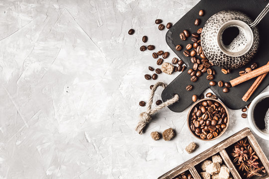 Coffee with  coffee beans on grey textured background. Top view with copy space. Background with free text space.