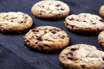 Chocolate cookies on wooden table. Chocolate chip cookies shot on table