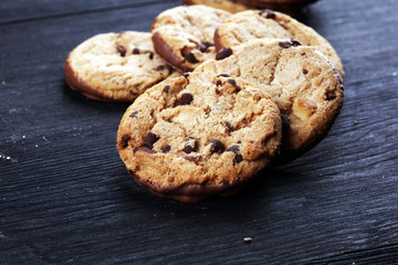 Chocolate cookies on wooden table. Chocolate chip cookies shot on table