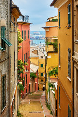 Old narrow street in Genoa - obrazy, fototapety, plakaty