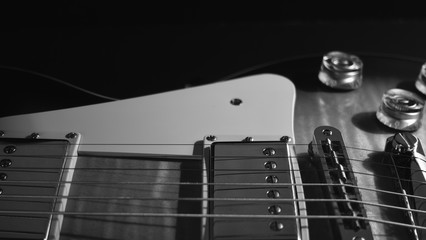 electric guitar . dark background . black and white .